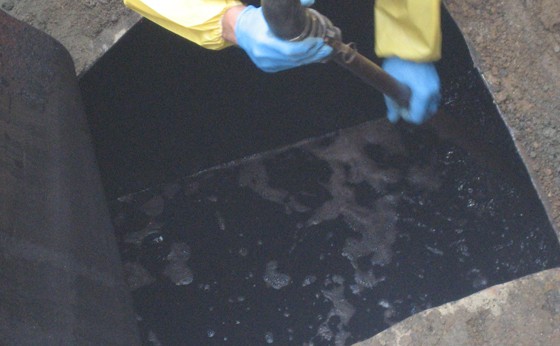 HAZ-MAT techs properly clean out the old oil and sludge with a vacuum